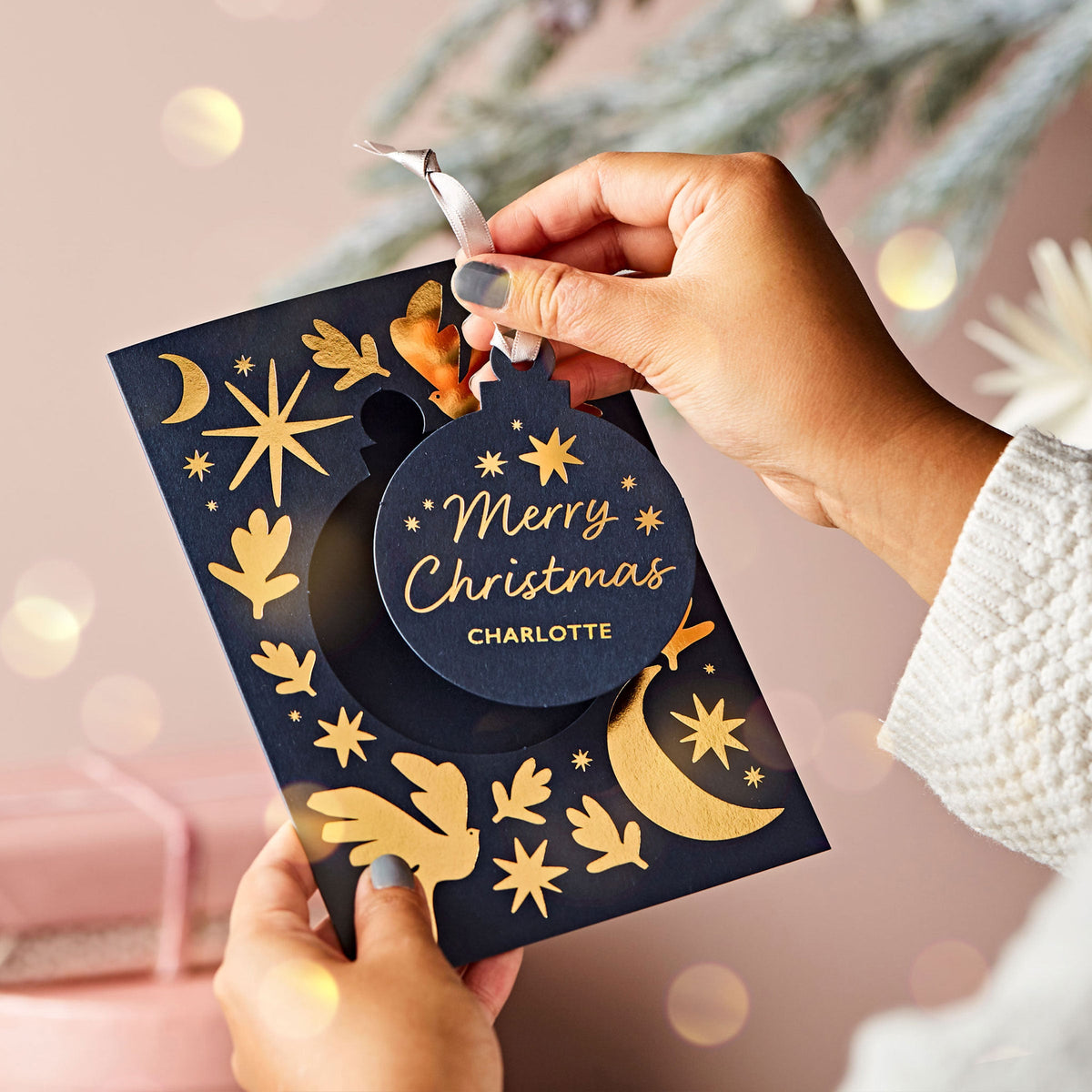 martha brook blog post what to write in a christmas card 30 christmas card messages person holding christmas card in front of a lit christmas tree