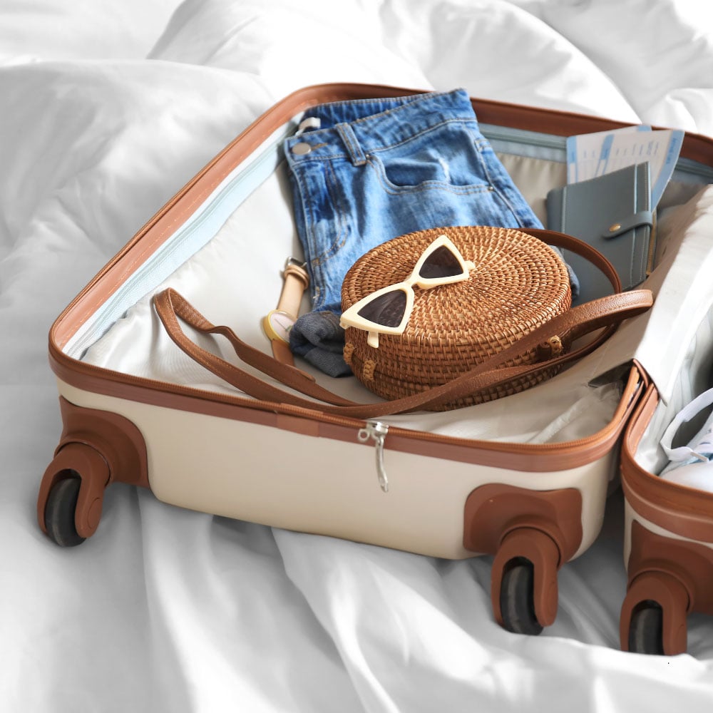 martha brook personalised stationery blog 15 things to take on holiday that you'll wish you'd thought of sooner packed open suitcase on a bed