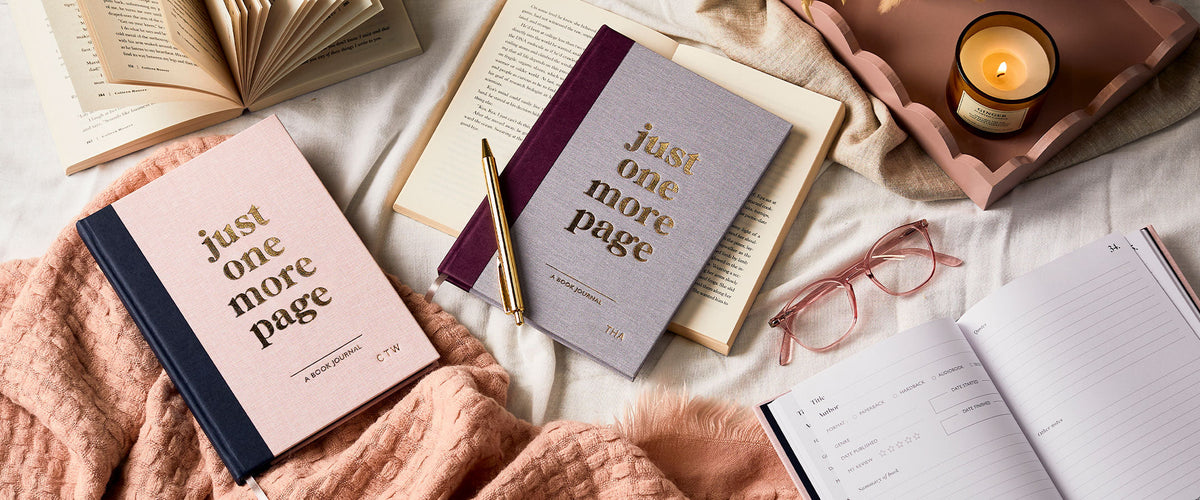 Martha Brook Personalised Book Journals in Pink and Lilac on a blanket with a lit candle