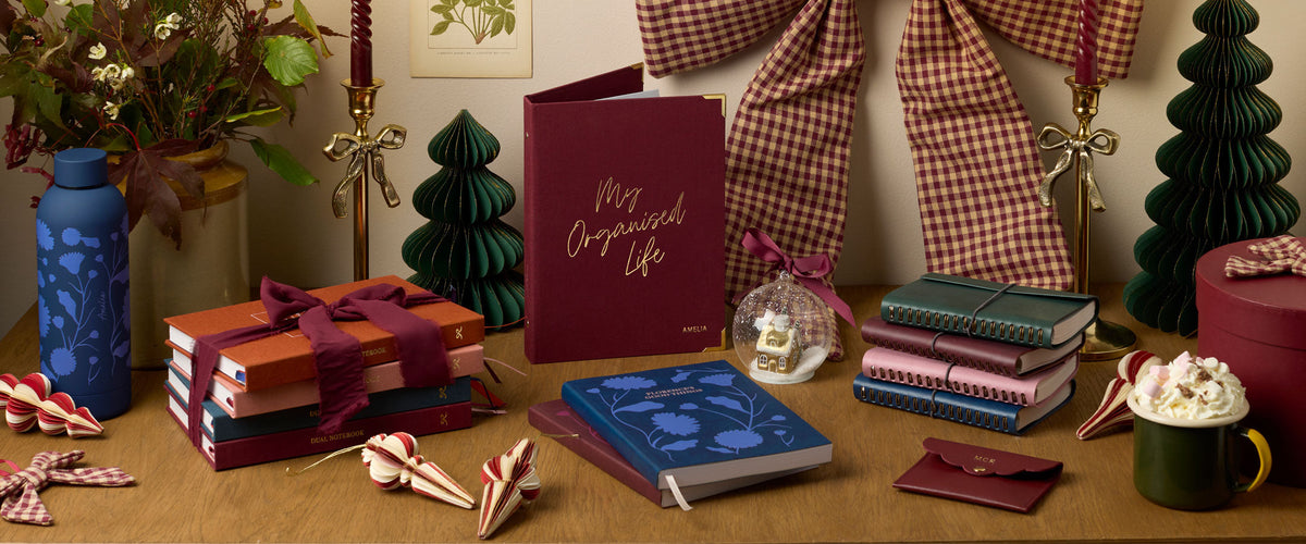 Martha Brook Personalised Christmas Gifts on a desk with a hot chocolate and Christmas decorations