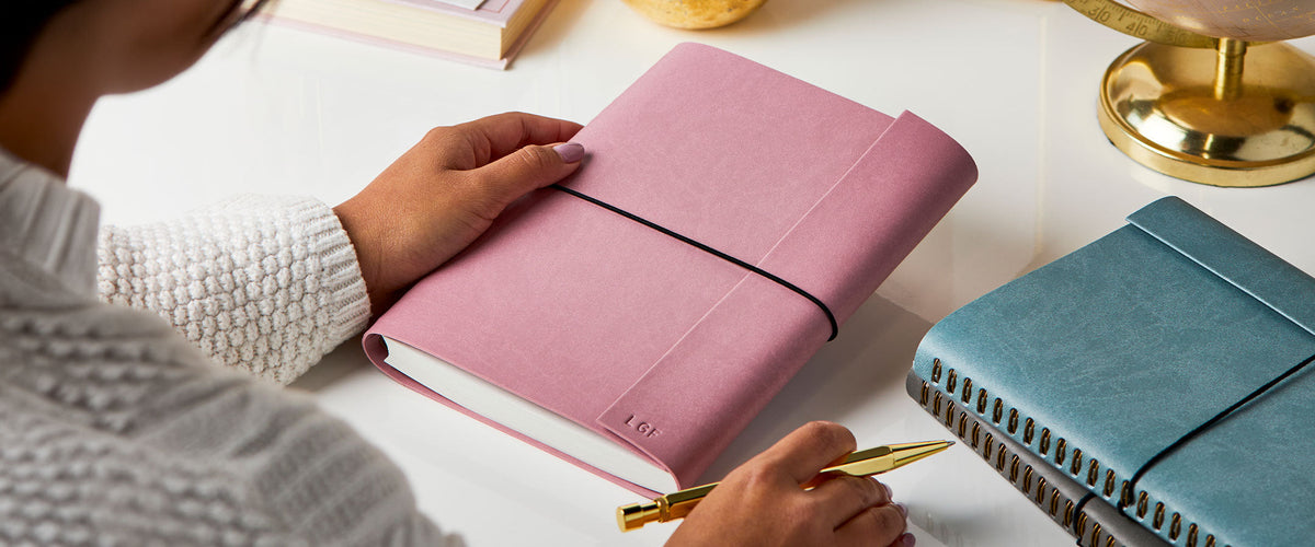 Martha Brook Personalised A5 Vegan Leather notebook being held on a white desk