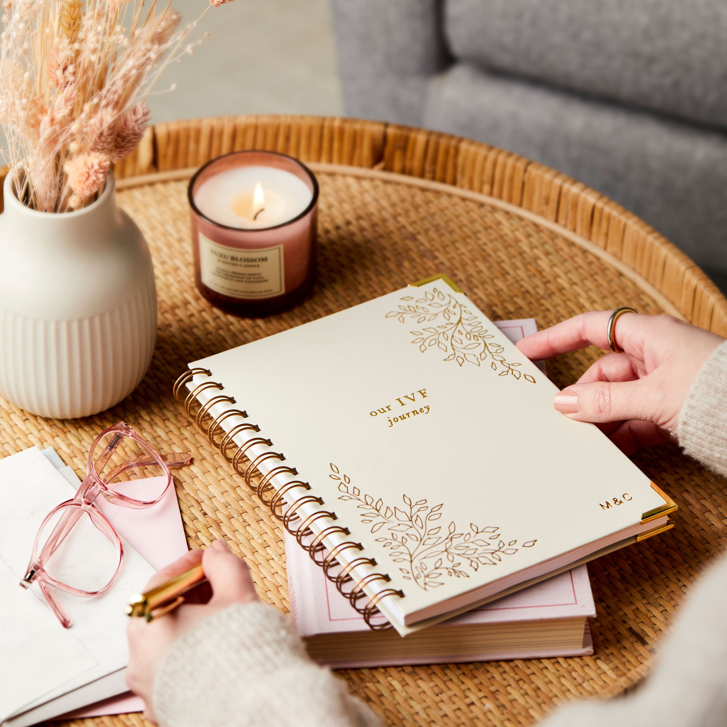 Martha Brook Personalised IVF Journal on a side table with hands