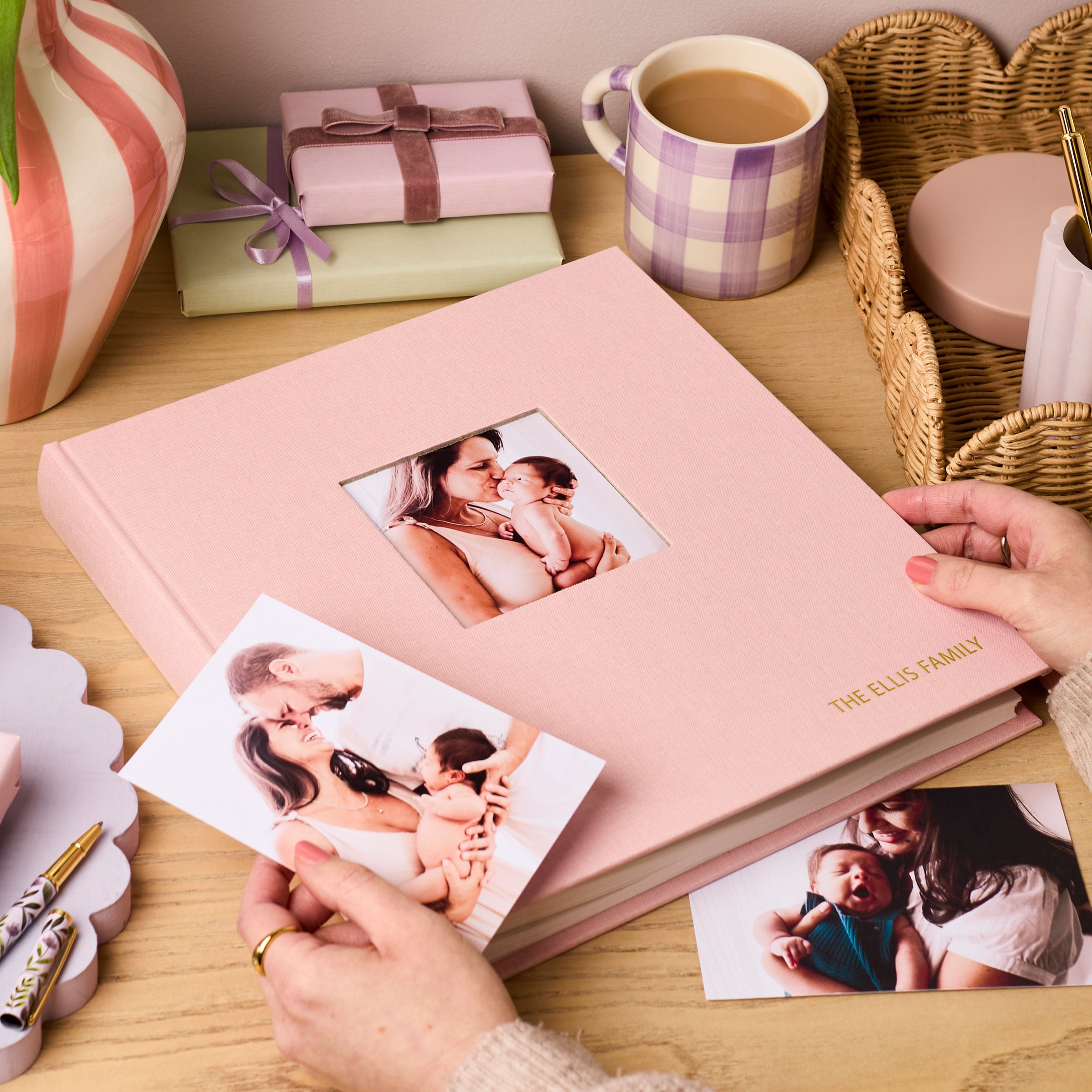Martha Brook pink Personalised Luxury Linen Photo Album with hands on a desk with a mug of tea