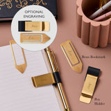 martha brook brass bookmark and navy and gold pen holder next to gold pen and notebook both with an engraved name on. There is a circle highlighting the engraved name examples.