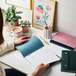 martha brook personalised stationery branded leather effect custom refillable notebook colourful logo notebooks open on desk with tea and pen pot