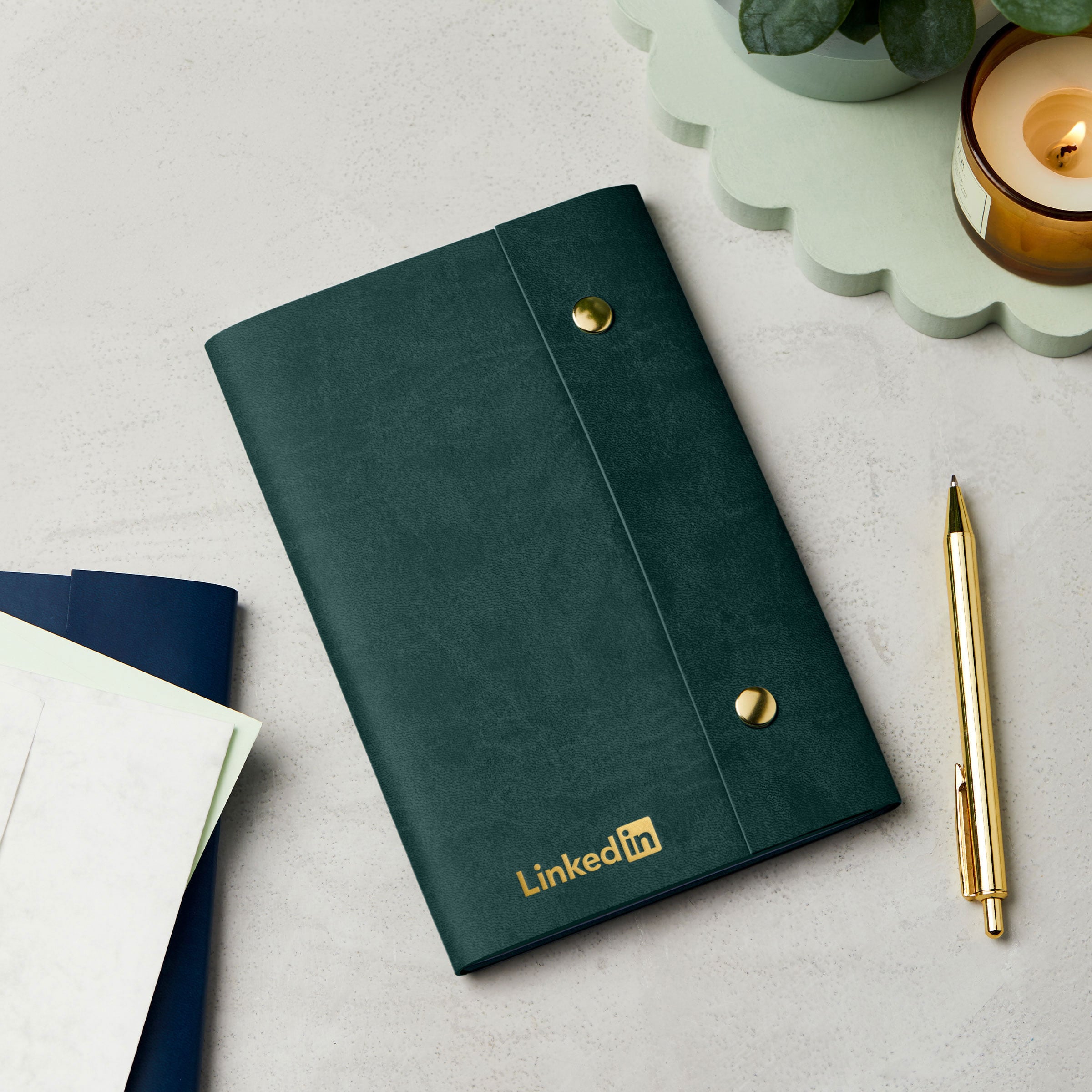martha brook personalised stationery branded leather effect custom refillable notebook green leather notebook with logo on desk