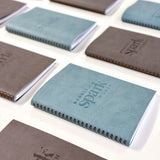 martha brook personalised stationery branded leather notebook blue and grey notebooks with logo on desk