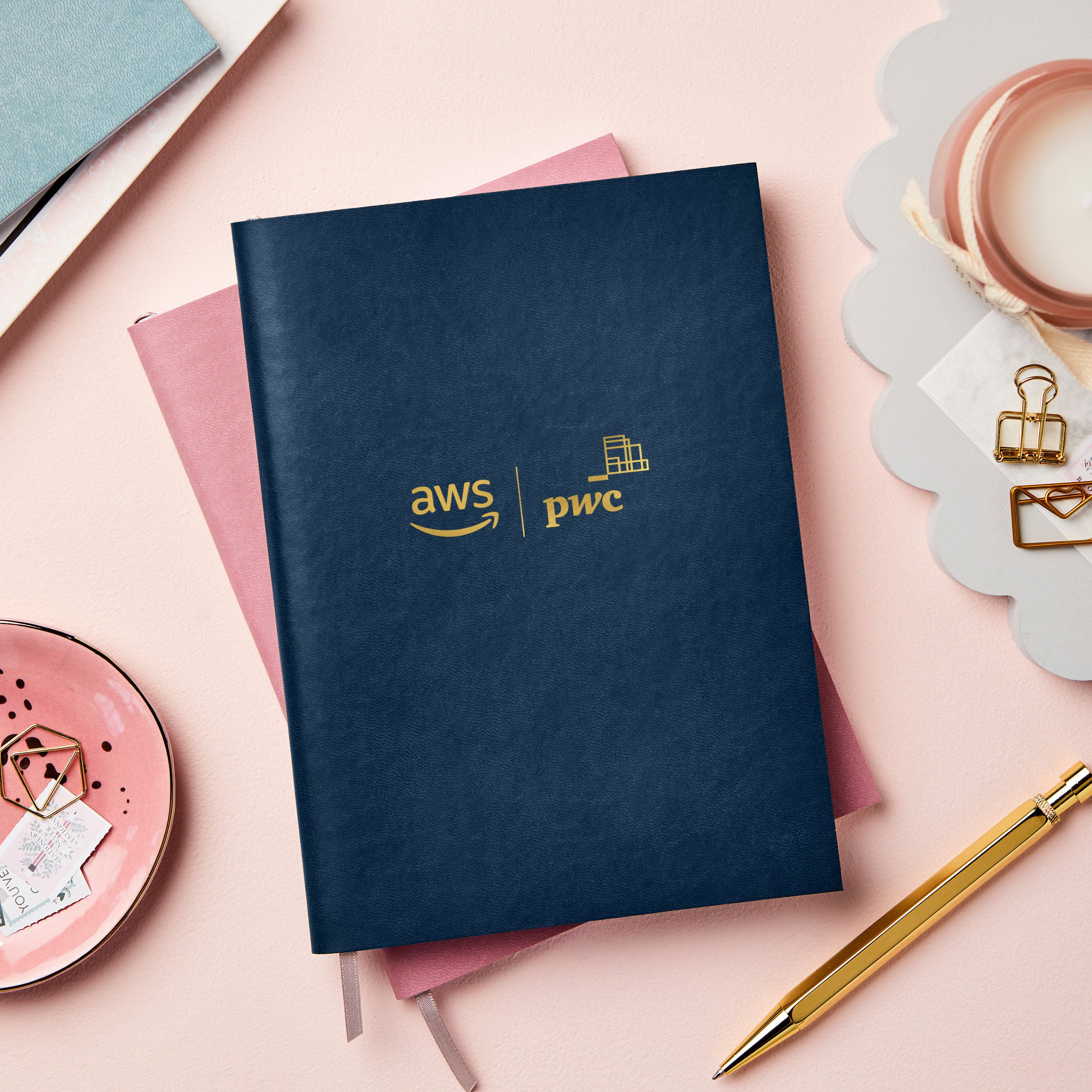 martha brook personalised stationery branded leather notebook navy notebook with gold logo on pink desk flatlay