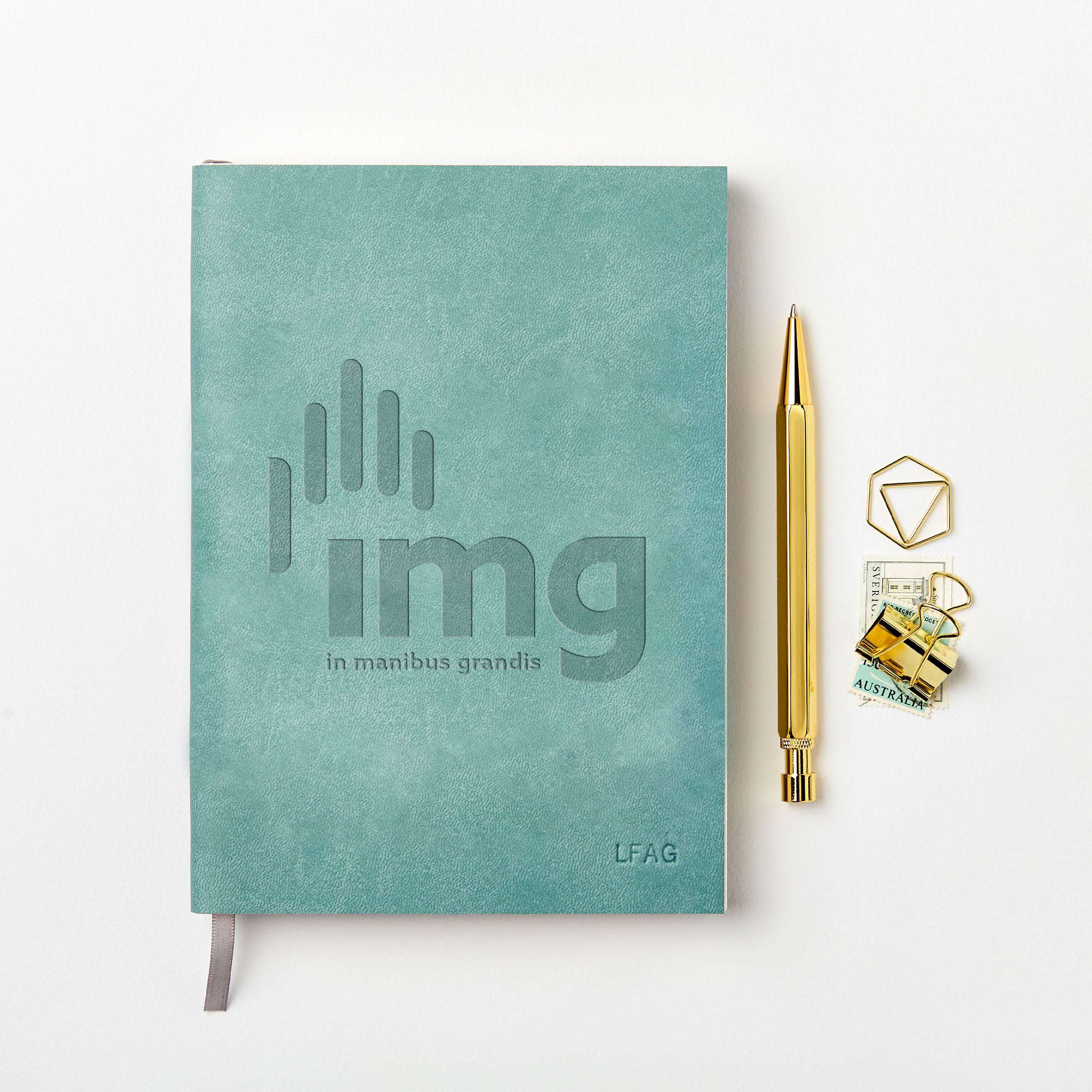martha brook personalised stationery branded leather notebook blue leather notebook with logo on desk with gold pen
