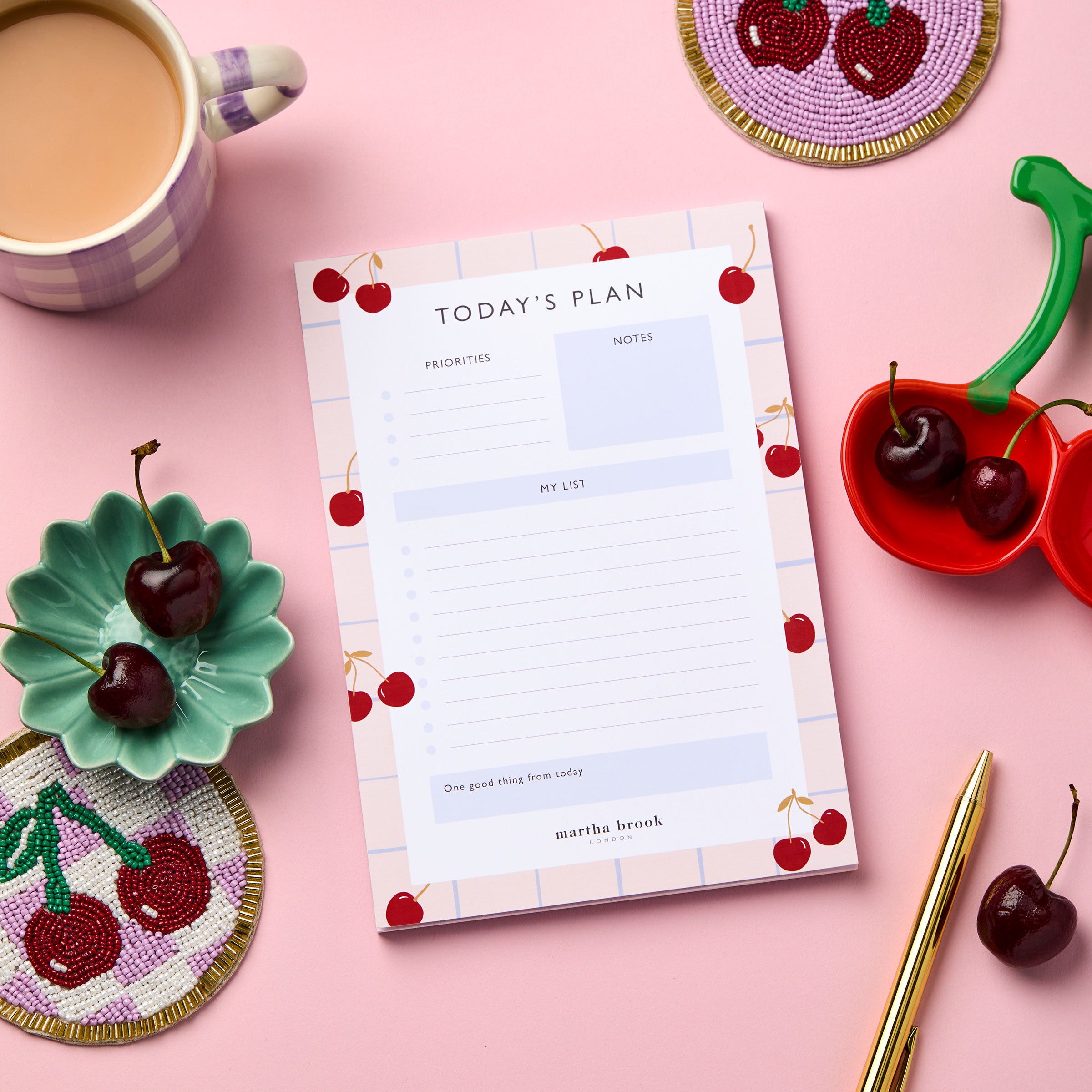 martha brook personalised stationery daily planner cherry desk pad with cherry coaster and trinket dish on pink background