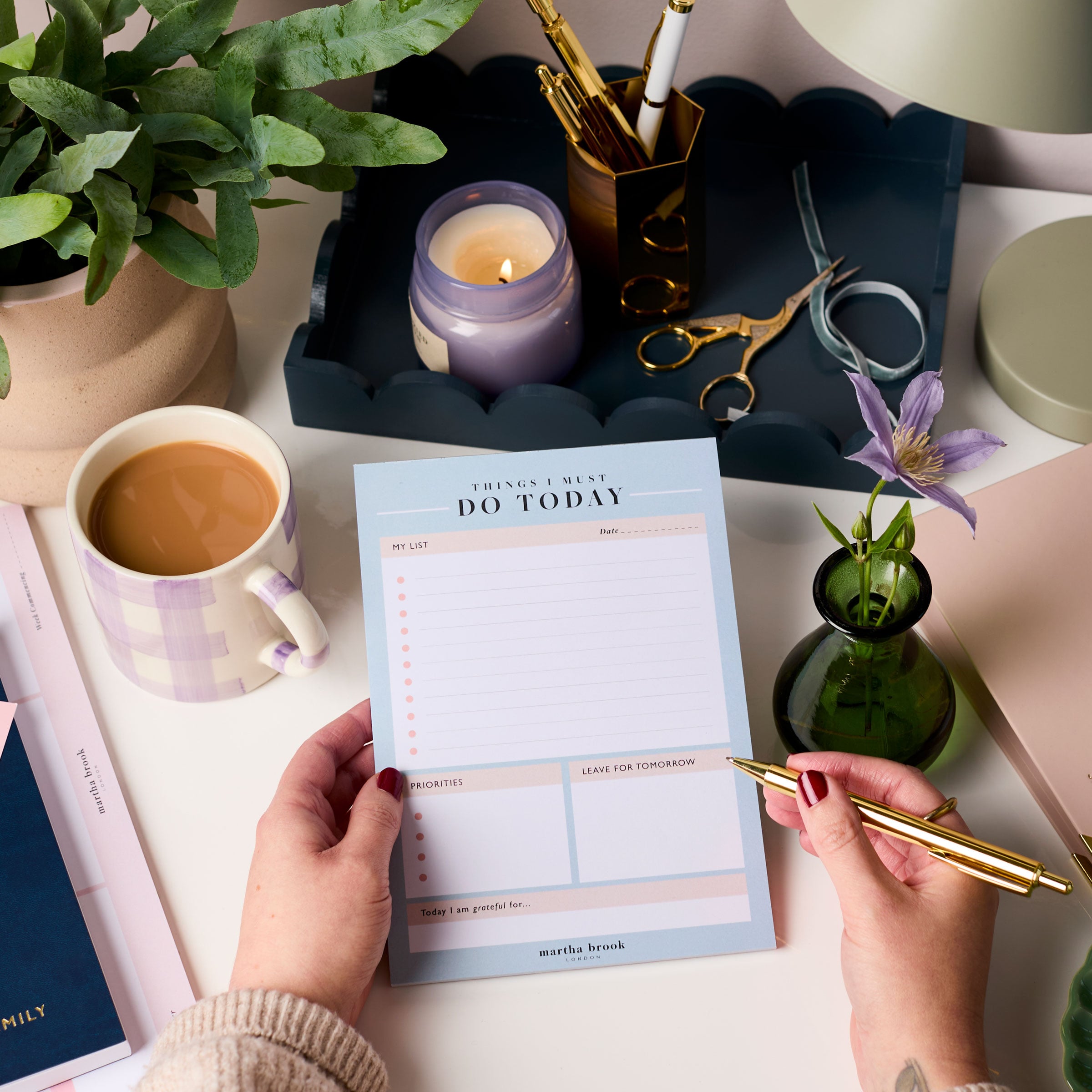 martha brook personalised stationery daily to do planner desk pad on a desk with a mug of tea and lilac candle
