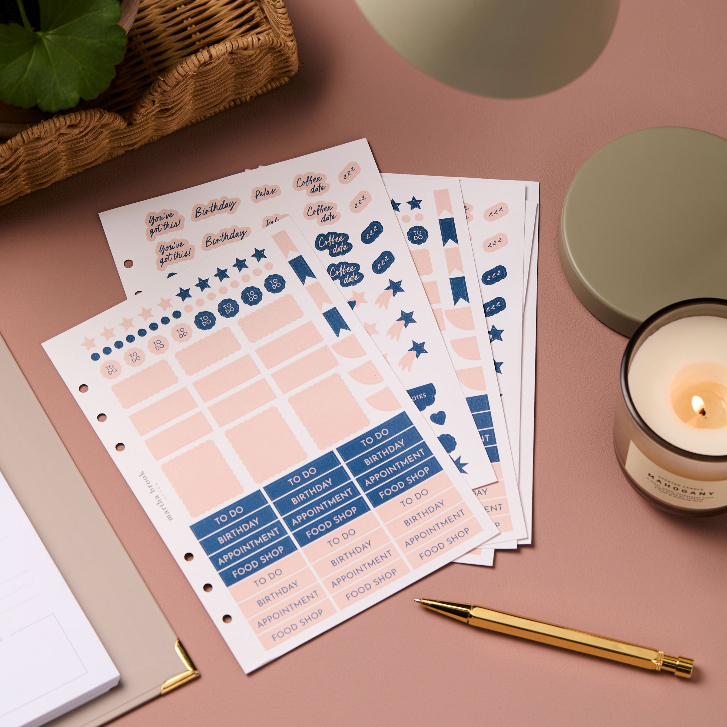 martha brook personalised stationery life planner stickers on a dusty pink background with a gold pen and candle