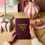 martha brook personalised stationery personalised 21st birthday gift softback notebook main image a dark red vegan leather notebook reads 'it's supposed to be fun turning 21' in gold foil