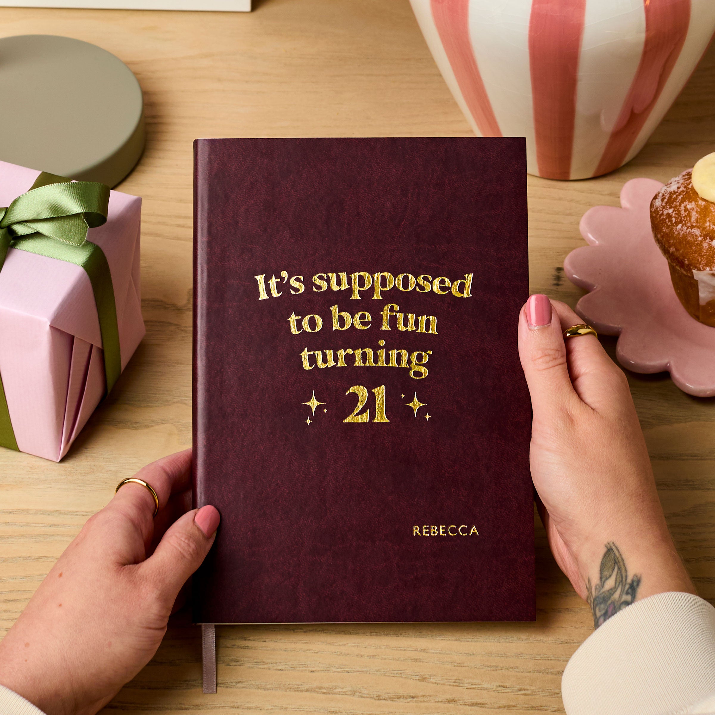 martha brook personalised stationery personalised 21st birthday gift softback notebook main image a dark red vegan leather notebook reads 'it's supposed to be fun turning 21' in gold foil