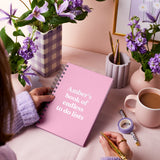 martha brook personalised stationery personalised any text customised hardback notebook in blush pink on a lilac themed desk with lilac flowers and a lilac scalloped pen pot