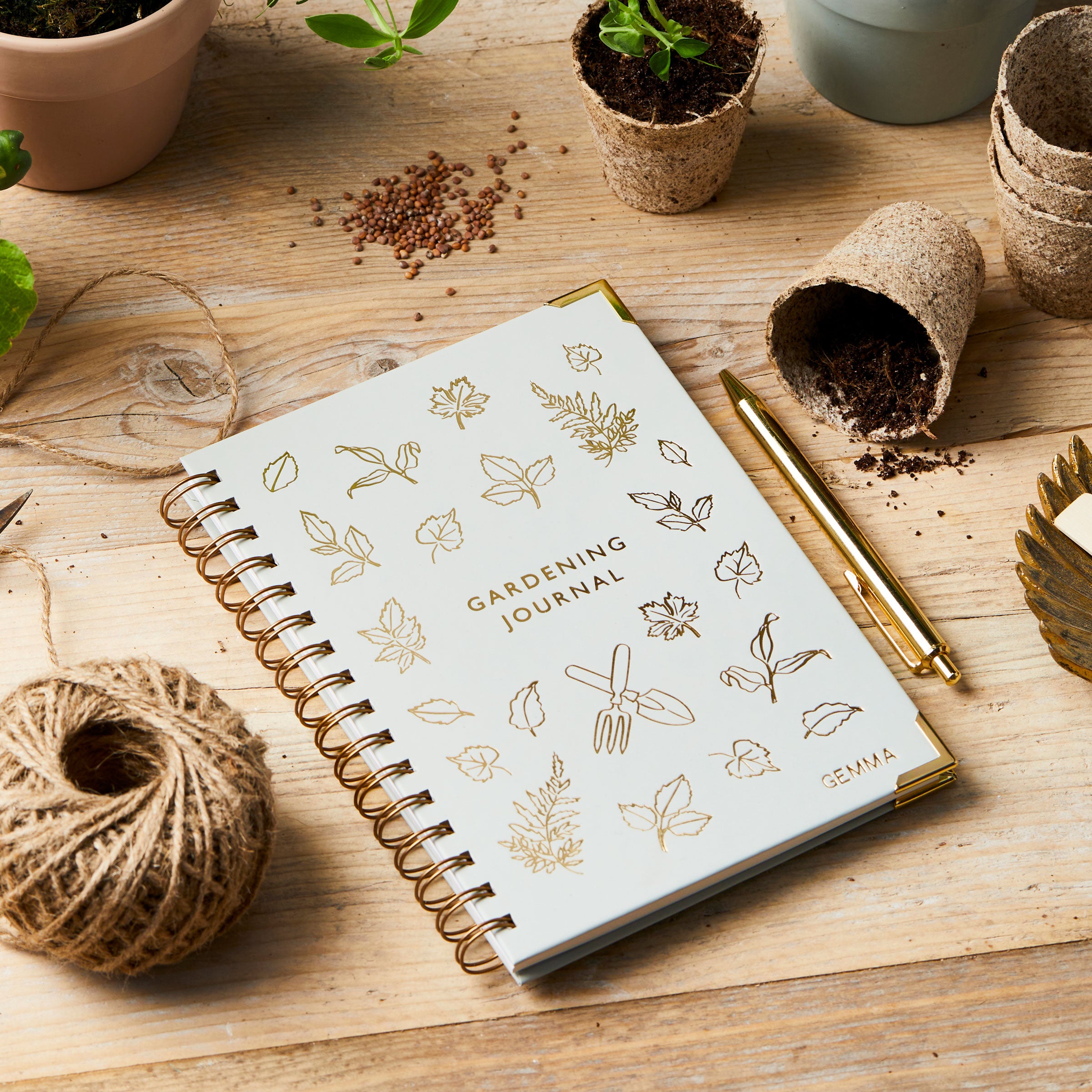 martha brook personalised stationery personalised hardback gardening journal on gardening table with pots and seeds