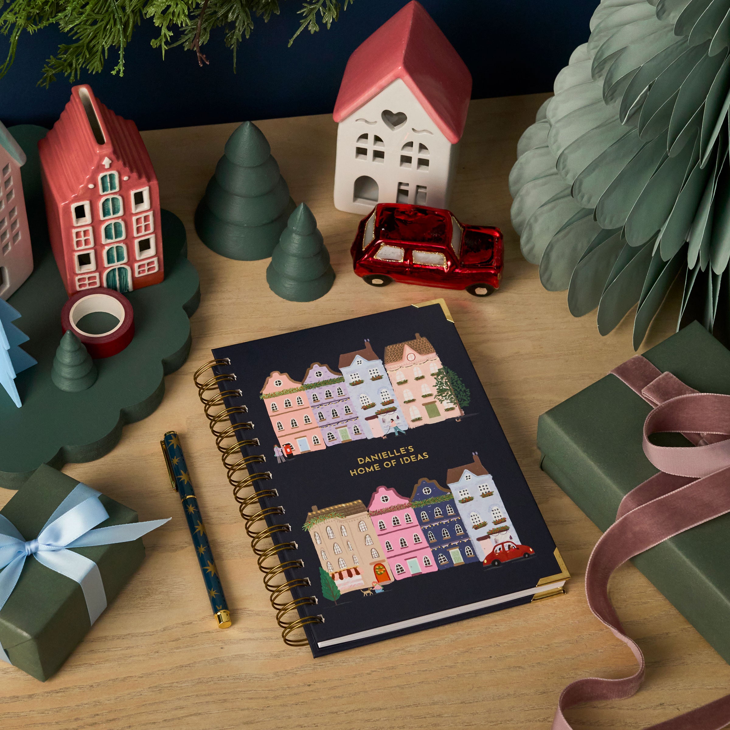martha brook personalised stationery personalised home of ideas hardback notebook on a christmas desk with painted ceramic houses and red car