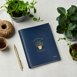 martha brook personalised stationery personalised leather effect gardening journal on gardening table in navy