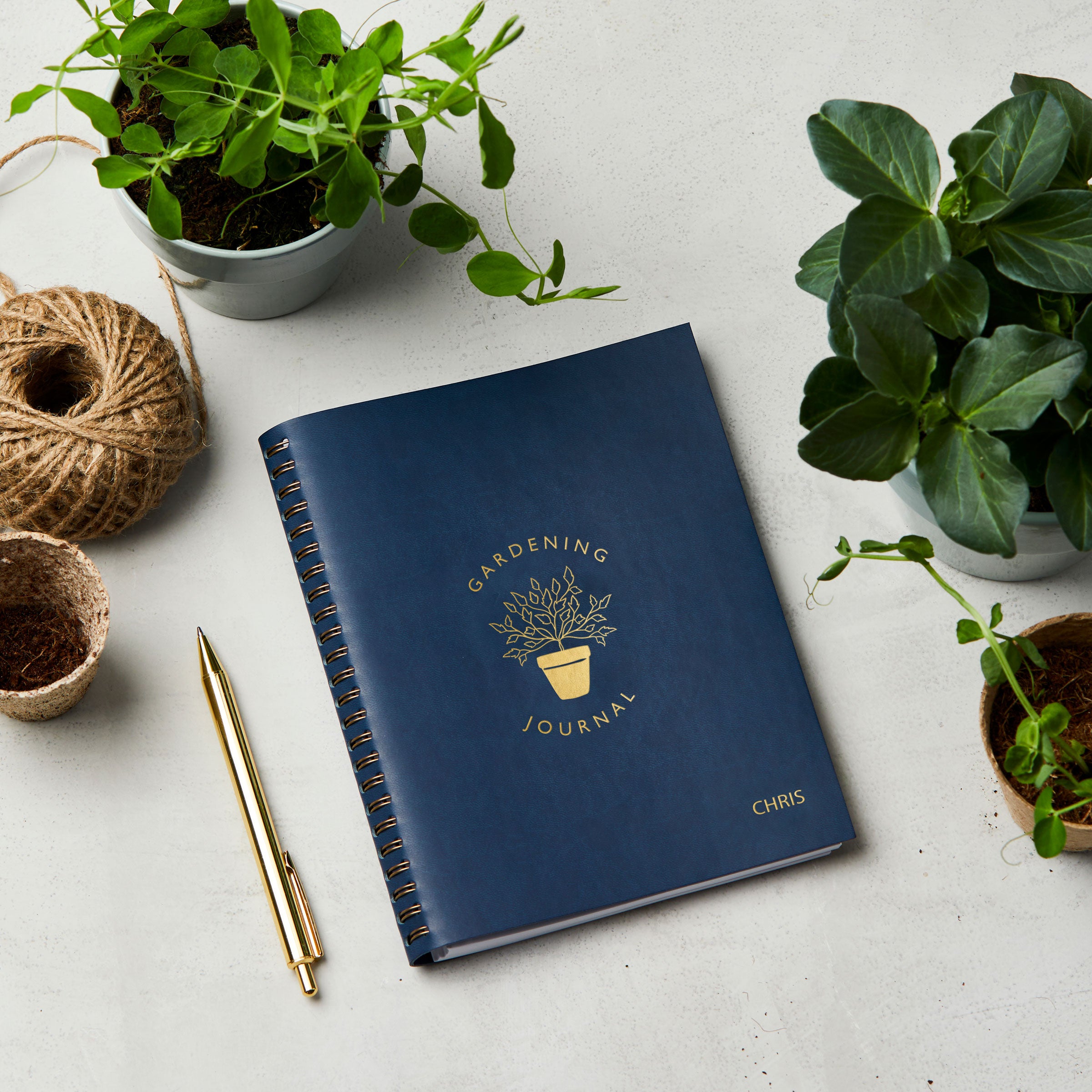martha brook personalised stationery personalised leather effect gardening journal on gardening table in navy