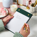 martha brook personalised stationery personalised leather effect refillable notepad in deep green on a desk with a candle and pen