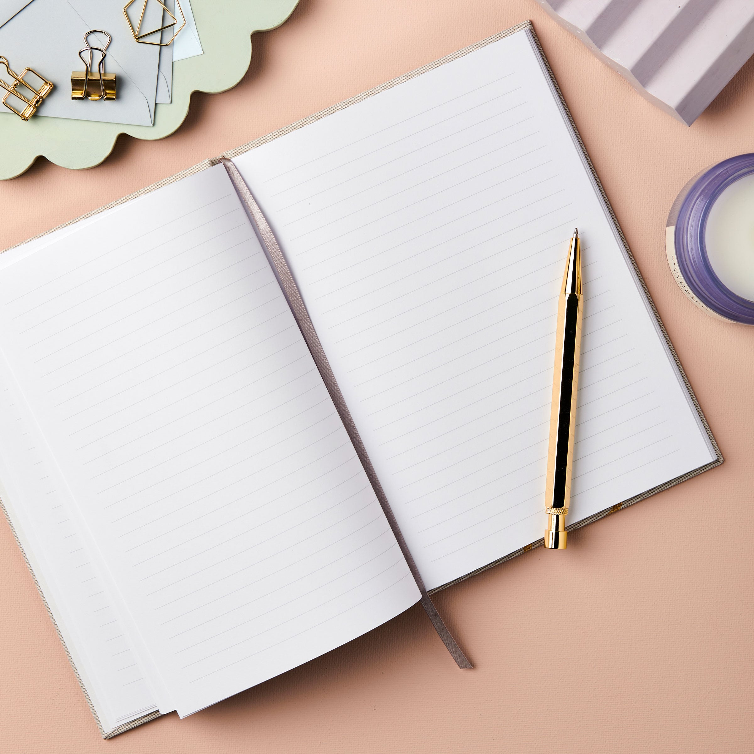 martha brook personalised stationery personalised ocean plastic notebooks personalised stay kind ocean plastic notebook sustainable notebook on desk with glass of water and candle