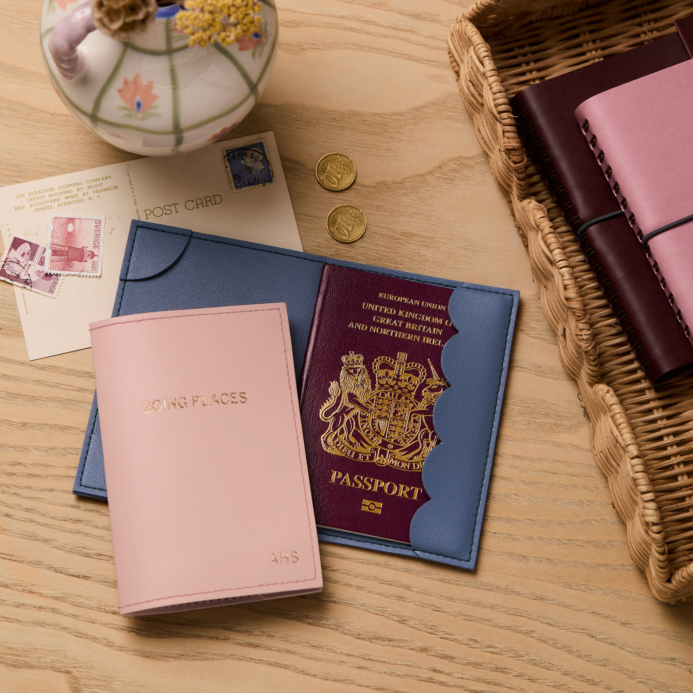 martha brook personalised stationery personalised passport holder on a wooden desk with postcards and dried flowers