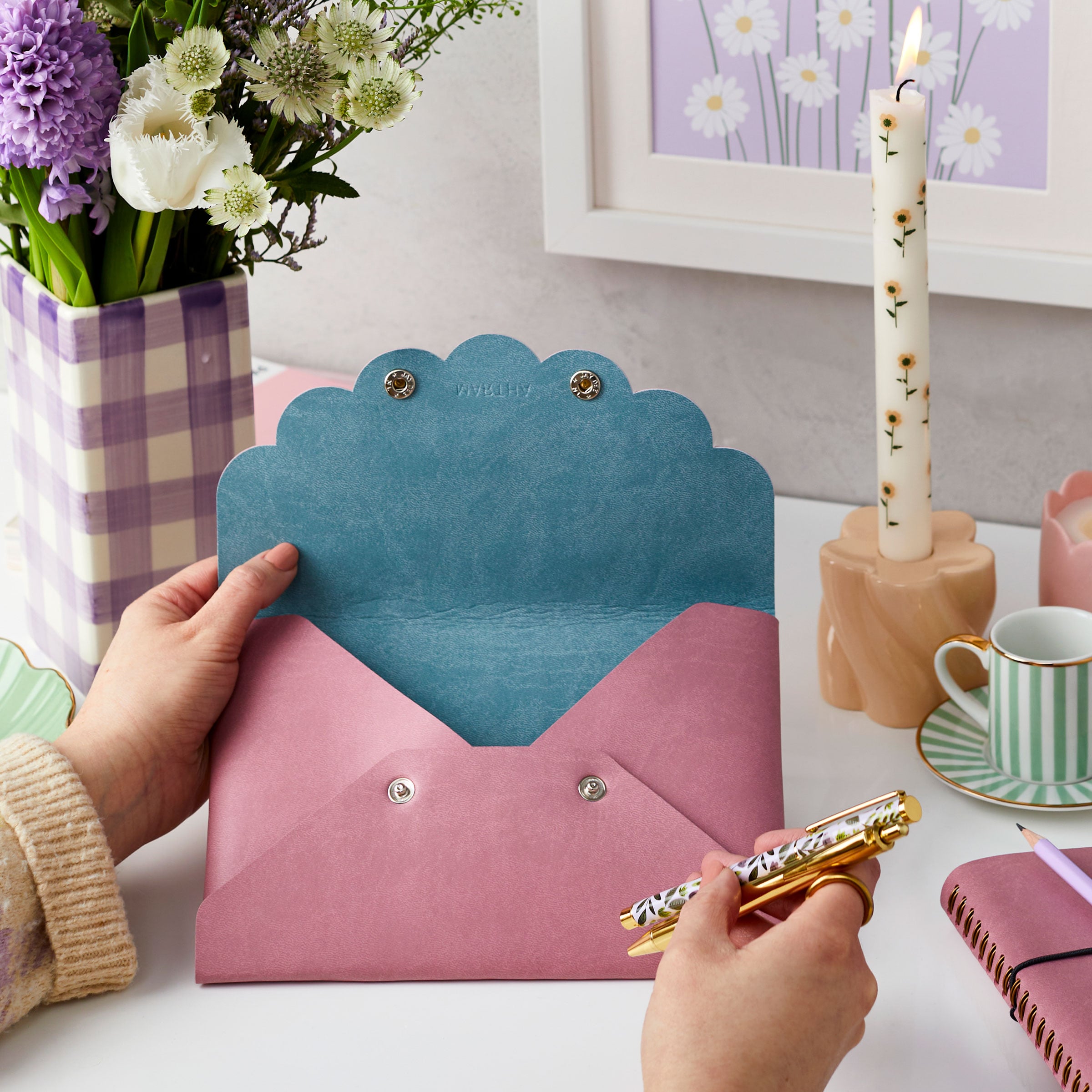 martha brook personalised stationery personalised vegan leather pouch in dusky rose with the personalisation martha next to flowers and a notebook and a floral candle on a desk open