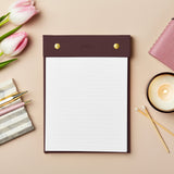 martha brook personalised stationery personalised vegan leather winter berry refillable notepad on a soft apricot colour background with a marbled pen holder and candle