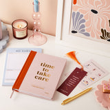 martha brook personalised stationery personalised wellness gift set wellness journal happiness daily planner pad post card gold pen on desk with candle and art print