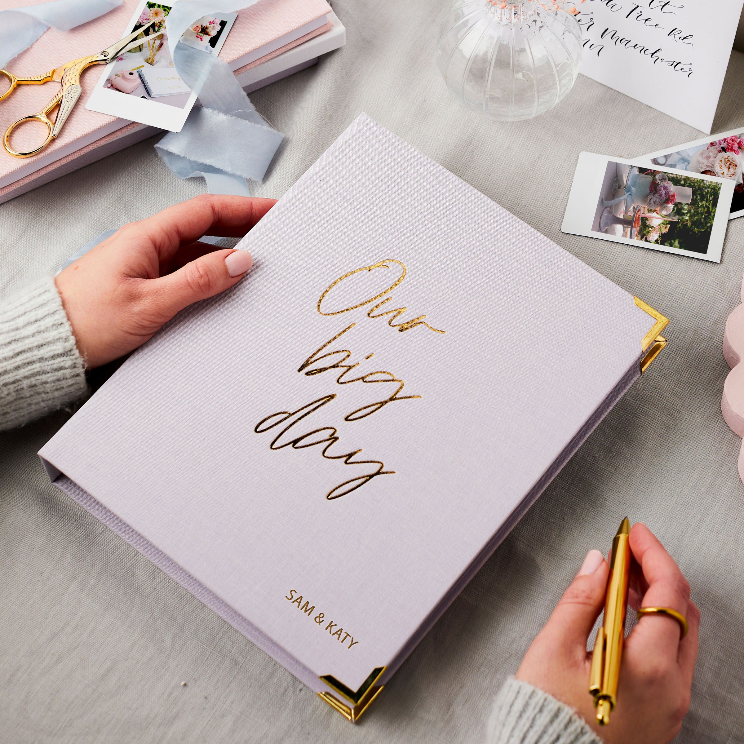 martha brook personalised stationery wedding stationery personalised lilac wedding planner and organiser on table with photos and scissors and ribbons