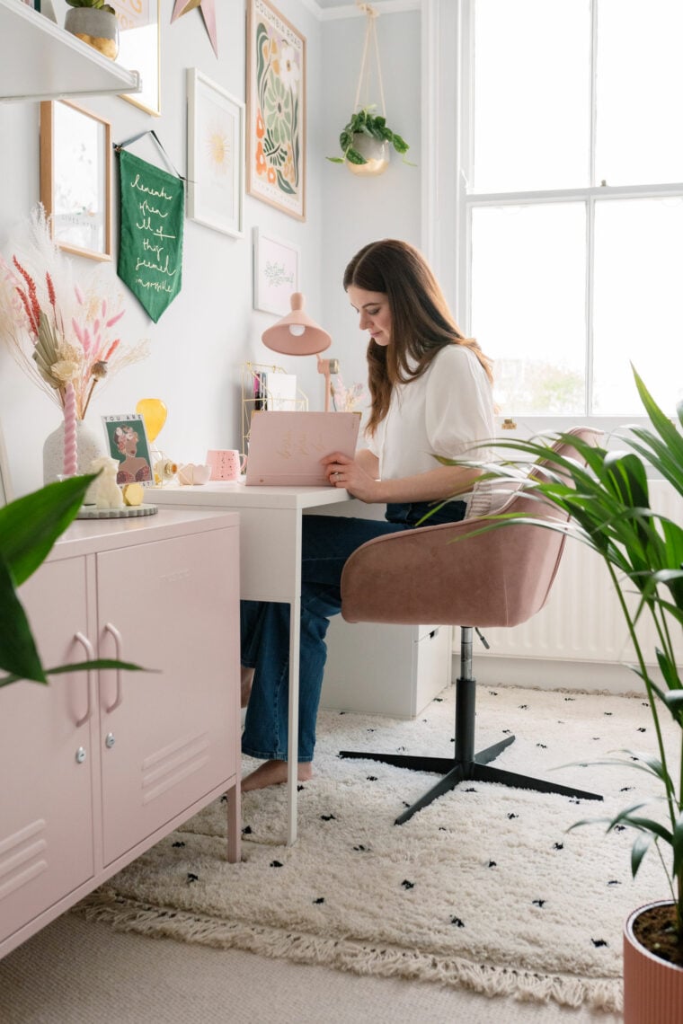 Girl working in beautiful home office surrounded by plants