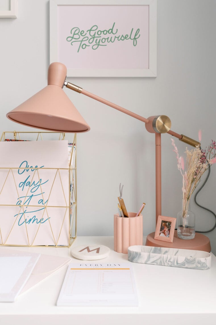 Pretty pink desk with pink desk lamp from Made.com, pink scallop pen pot, gold document organiser and desk pads.