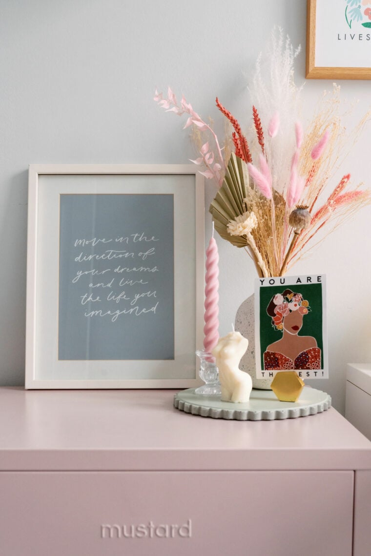 Blush pink mustard locker with print on top, candles and dried flowers