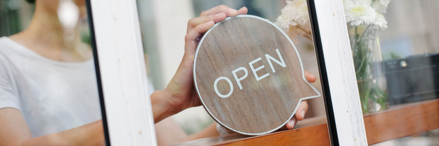 martha brook blog post 8 ways to shop with meaning this christmas person holding open sign in shop window