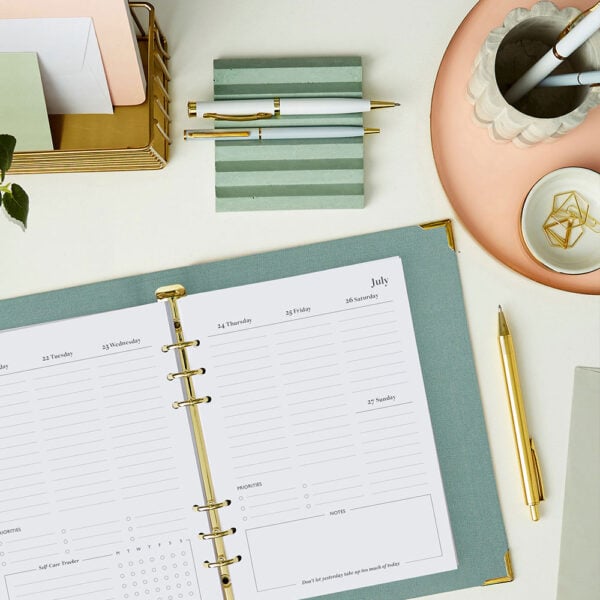 martha brook personalised stationery how to choose your perfect 2025-2026 diary or planner blog open green planner on desk with gold pen, pen holder and pen pot
