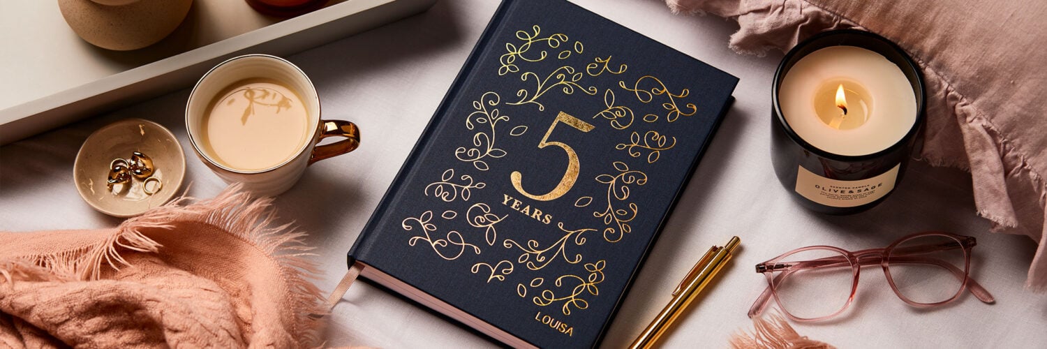 martha brook blog post 6 reasons you should keep a five year diary on a bed with tea glasses and canadles