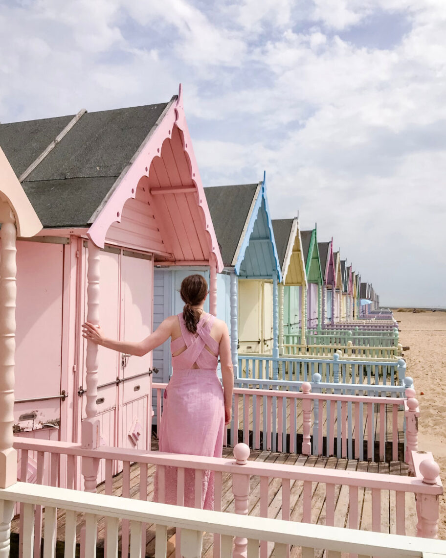 martha brook personalised stationery blog 10 things to do in the summer to keep the whole family entertained woman stood in front of a long row of colourful pastel beach houses
