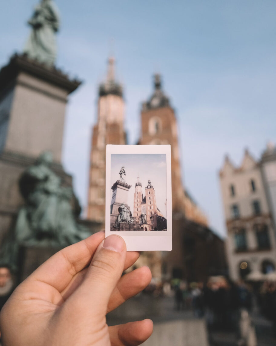 martha brook personalised stationery blog 15 things to take on holiday that you’ll wish you’d thought of sooner instant polaroid camera. A person holds an instant photograph of a building up in front of that building