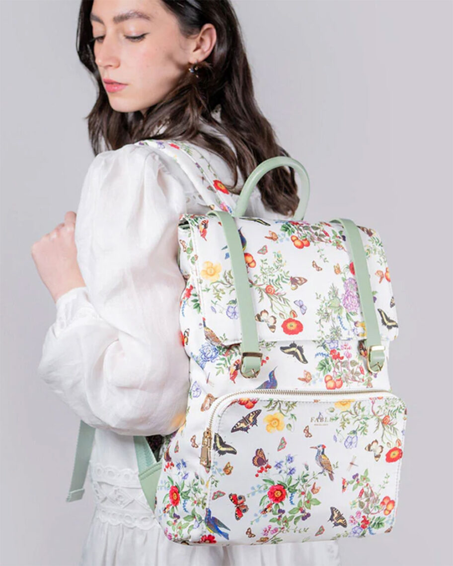 Martha Brook personalised stationery blog 10 dreamy school supplies fror grown-ups that give us that back to school feeling fable england alice garden backpack woman wearing a white backpack with sage green leather accents and a dainty flower pattern