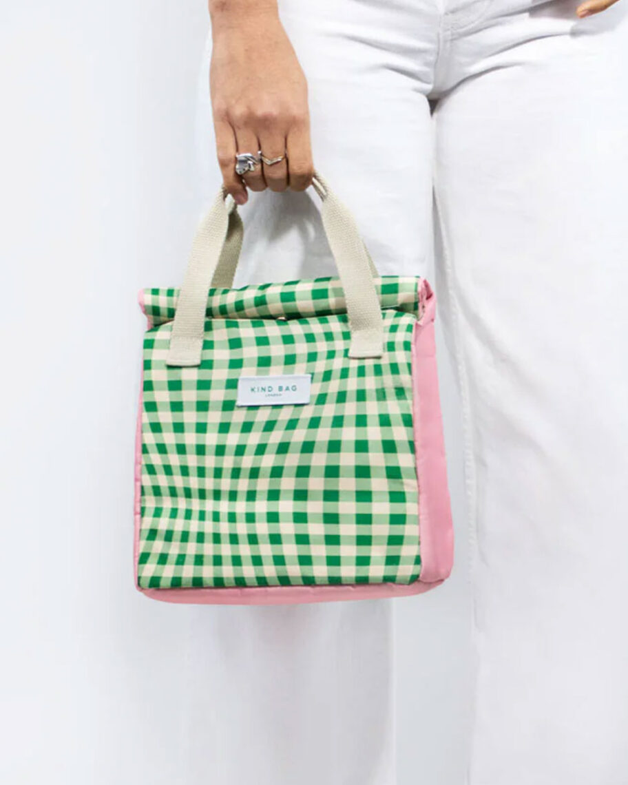 Martha Brook personalised stationery blog 10 dreamy school supplies for grown-ups that give us that back to school feeling kind bag lunchbox. Woman in white jeans holding a green wavy gingham lunch bag with a cream handle and pink sides