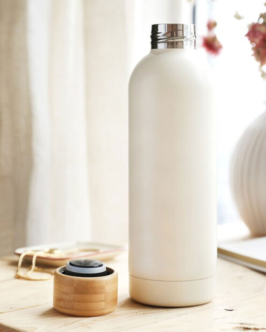 Martha Brook personalised stationery blog 10 dreamy school supplies for grown-ups that give us that back to school feeling lisa angel water bottle. A white metal water bottle with a wooden lid on a windowsill with a white curtain in the backgorund