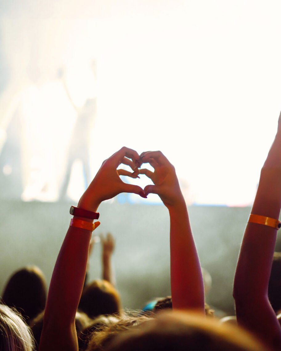 Martha Brook personalised stationery blog 10 ideas for what to get the person who has everything theatre direct tickets and dinner package. A person at a concert with their hands up in the air making a heart sign with their hands