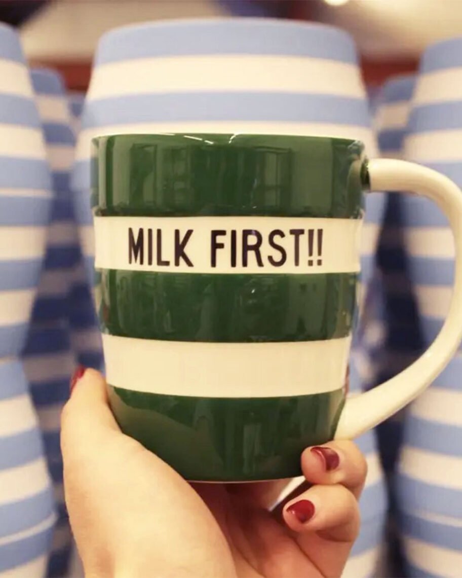 Martha Brook personalised stationery blog 10 ideas for what to get the person who has everything cornishware personalised mug. Green striped mug that says 'milk first!!' in black block capitals.