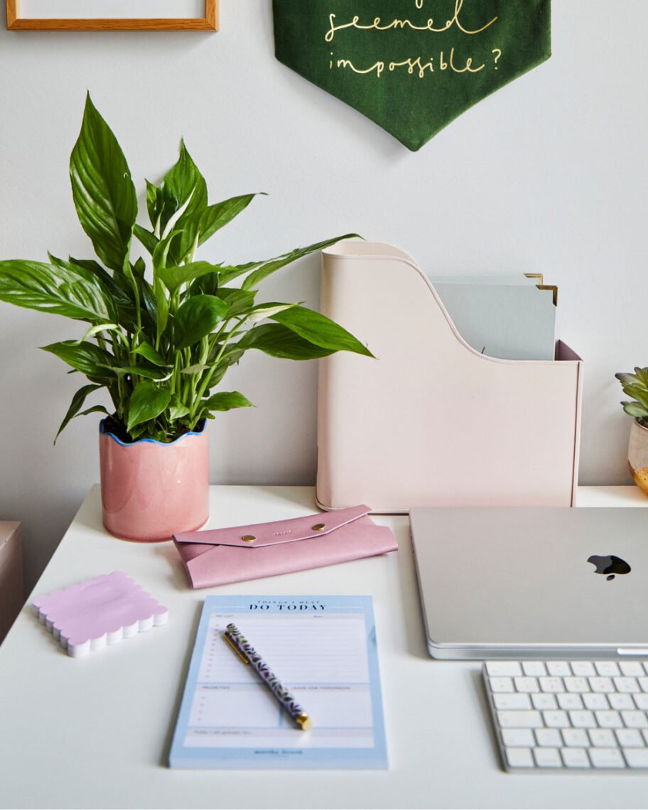 Martha Brook personalised stationery blog Our university essentials and top tips if you’re heading off to study this year pretty desk space with a plant in a pink pot, a pink pencil case, a pink file holder and laptop