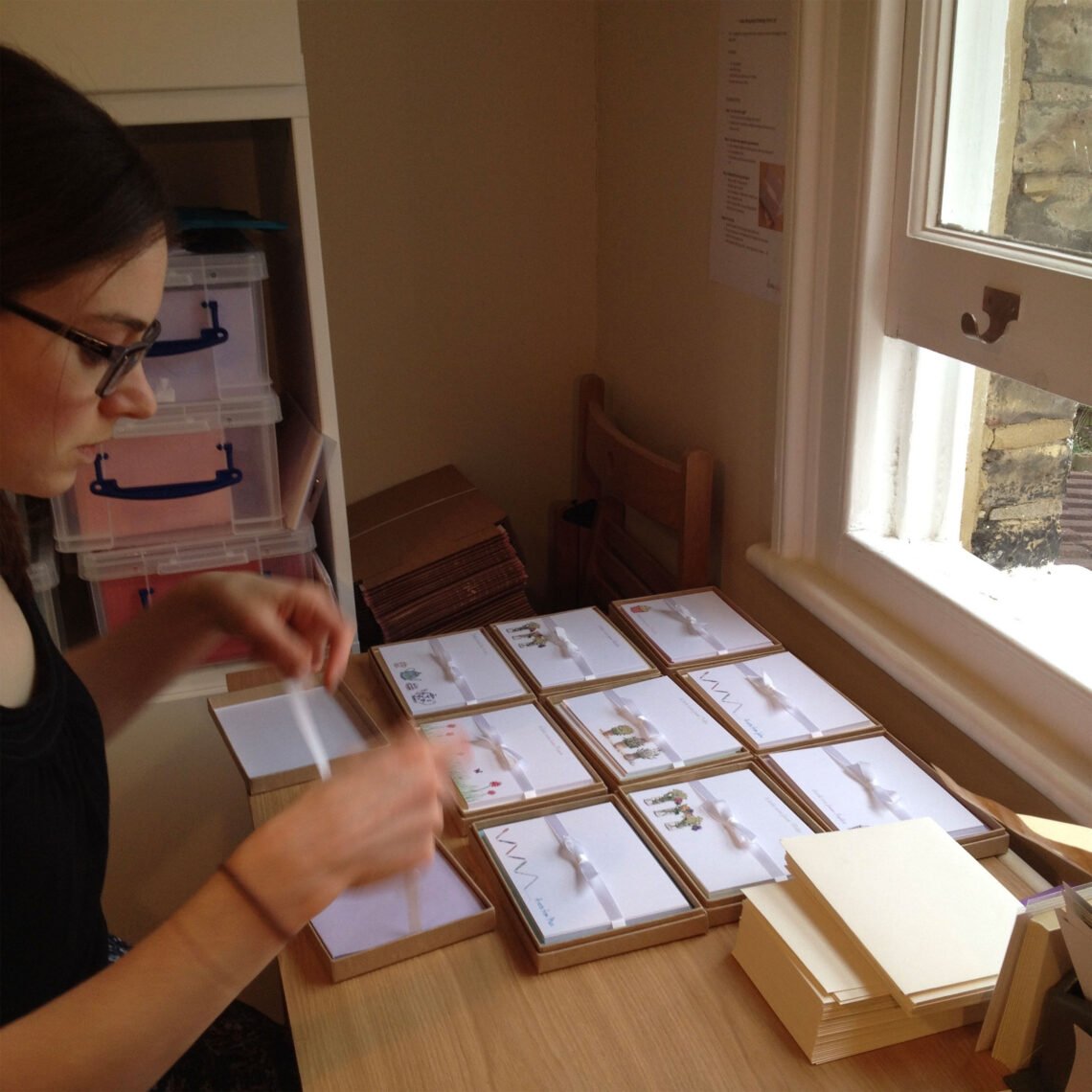 martha brook blog post 12 lessons from 12 years of Martha Brook martha sat at desk at home creating stationery orders from hand
