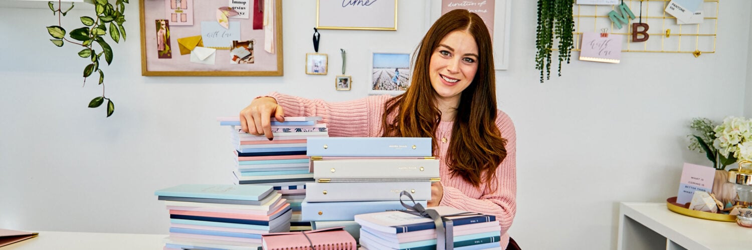 martha brook blog post 12 lessons from 12 years of Martha Brook martha sat at a desk leaning on piles of stationery