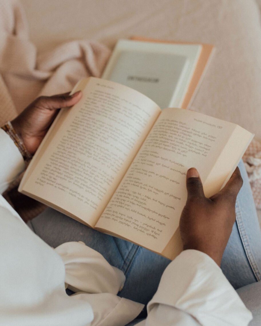 martha brook blog post 7 easy ways to get back into reading a person reading on the sofa