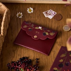 martha brook personalised stationery personalised berries and brambles mini pouch on a desk with small stamps and leaves