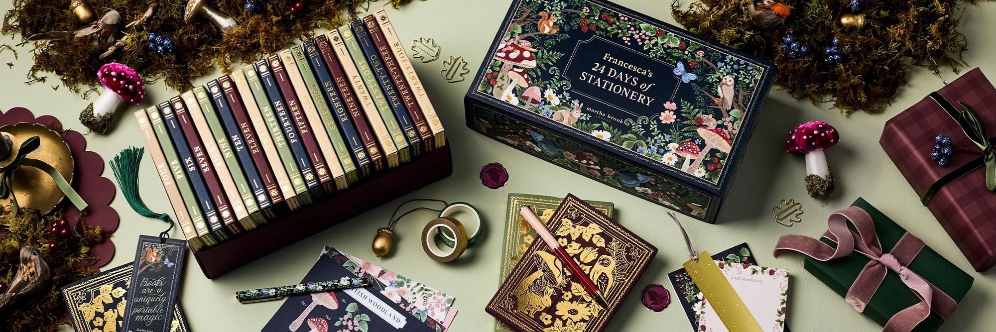 The Martha Brook 24 Days of Stationery Advent Calendar, with its 24 book-style boxes beside the woodland-illustrated lid