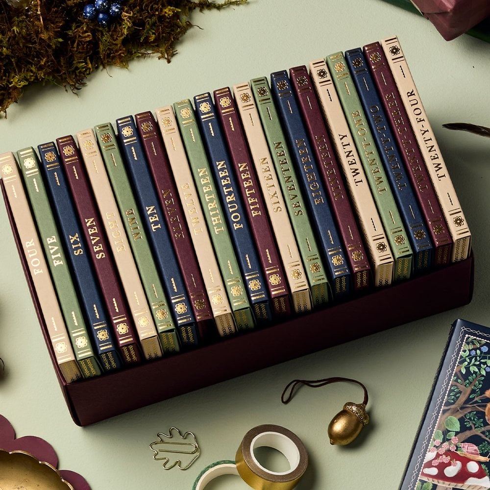 The 24 numbered book-style boxes of the stationery advent calendar in their tray